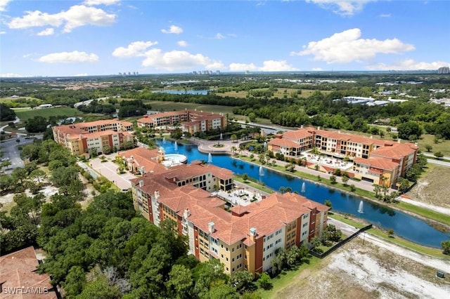 21490 Strada Nuova Cir Unit D307, Estero, FL 33928 - drone / aerial view of a large body of water, apartment complex, and a tree filled landscape