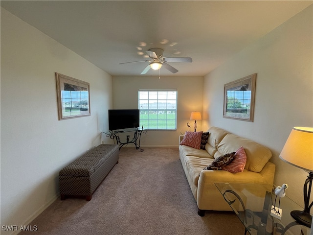 carpeted living room featuring ceiling fan