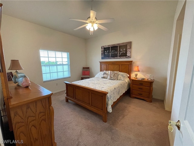 bedroom with vaulted ceiling, light colored carpet, and ceiling fan