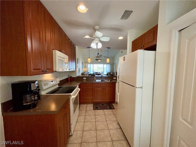 kitchen featuring sink, hanging light fixtures, light tile patterned floors, kitchen peninsula, and white appliances