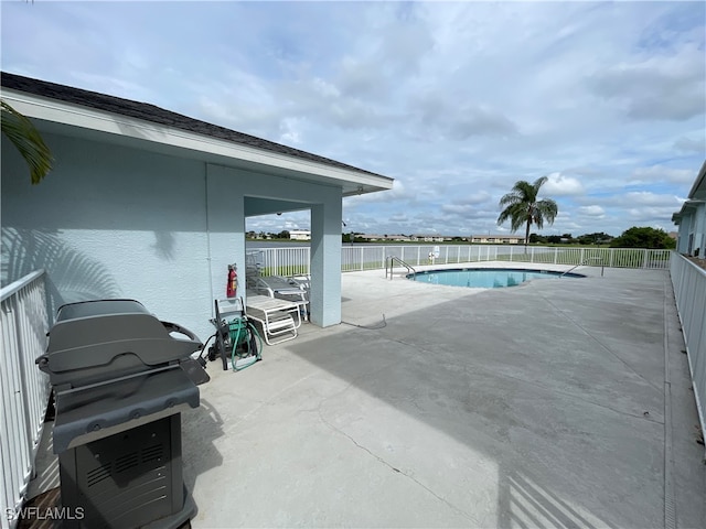 view of pool featuring area for grilling and a patio area