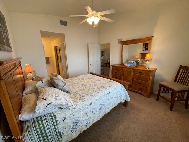 bedroom with carpet flooring and high vaulted ceiling