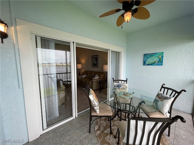 sunroom featuring ceiling fan