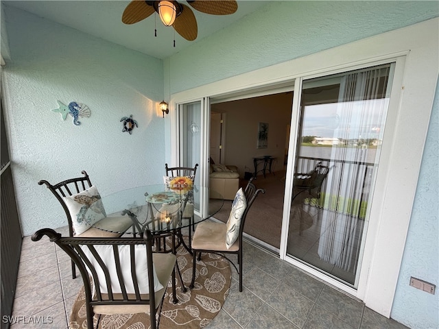 sunroom / solarium featuring ceiling fan