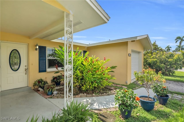 view of exterior entry featuring a garage