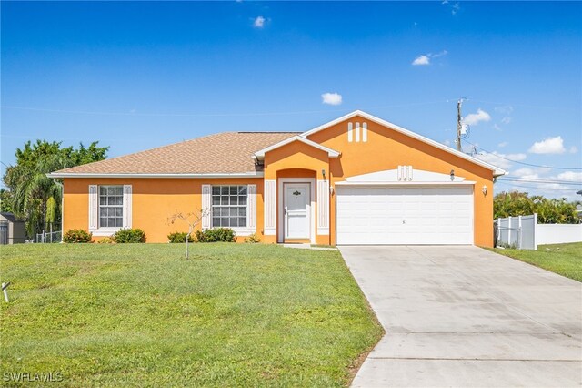 ranch-style house featuring a front lawn and a garage