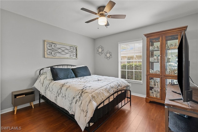 bedroom featuring ceiling fan and dark wood-type flooring