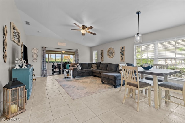 living room featuring ceiling fan, vaulted ceiling, and light tile patterned floors