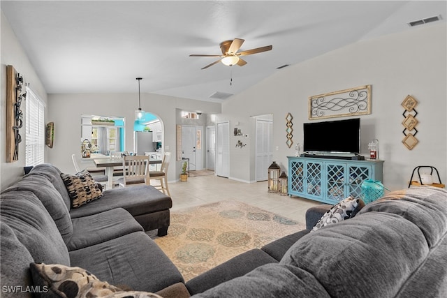 tiled living room with ceiling fan and lofted ceiling