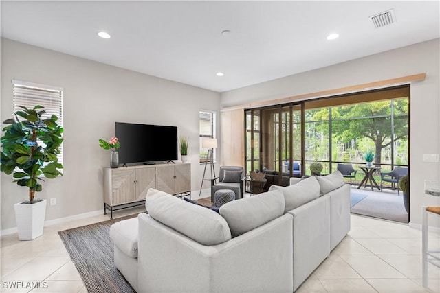 11077 Esteban Dr, Fort Myers, FL 33912 - living area featuring light tile patterned floors, visible vents, baseboards, and recessed lighting