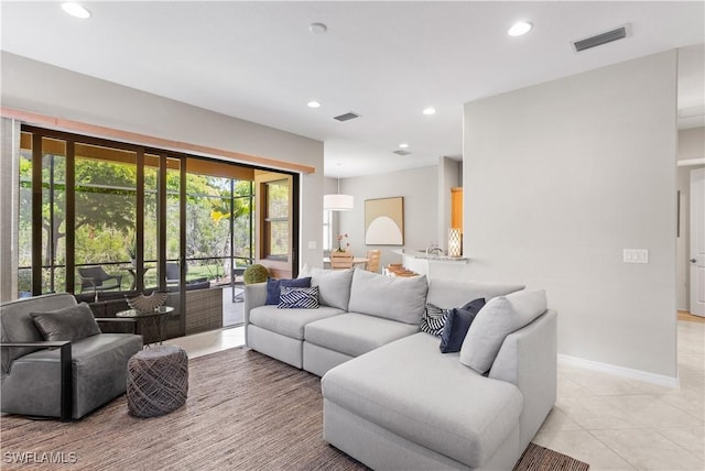 11077 Esteban Dr, Fort Myers, FL 33912 - living room with light tile patterned floors, visible vents, baseboards, and recessed lighting