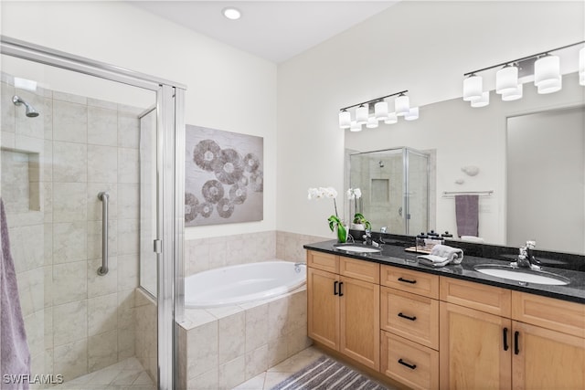 bathroom featuring tile patterned flooring, vanity, and plus walk in shower