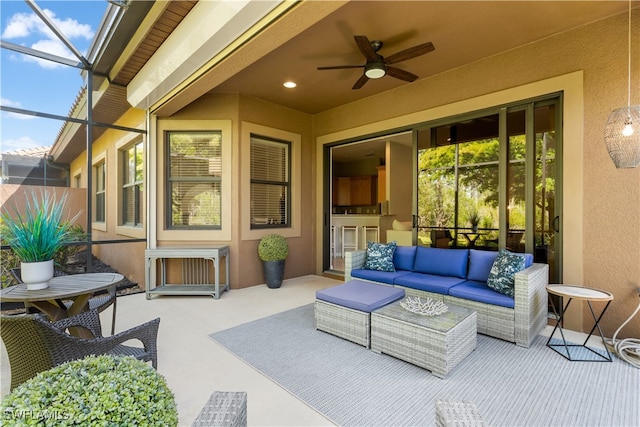 view of patio / terrace featuring outdoor lounge area, a lanai, and ceiling fan