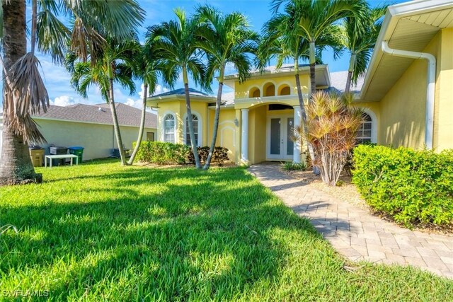 mediterranean / spanish-style home with a front lawn