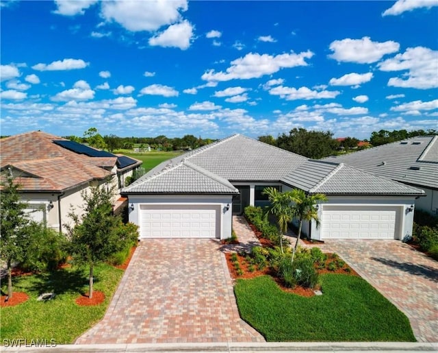 16665 Rolling Rock Blvd, Alva, FL 33920 - ranch-style home with an attached garage, driveway, a tile roof, and stucco siding