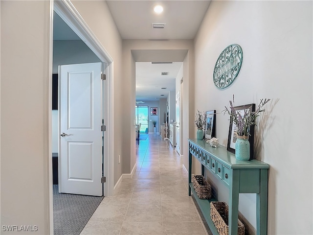 hallway with light colored carpet