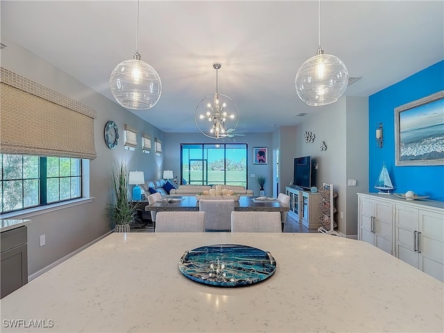 dining area with a chandelier and a healthy amount of sunlight