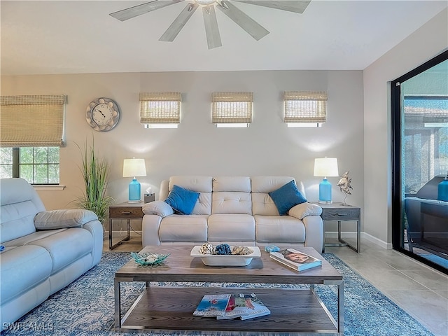 living room featuring ceiling fan and tile patterned flooring