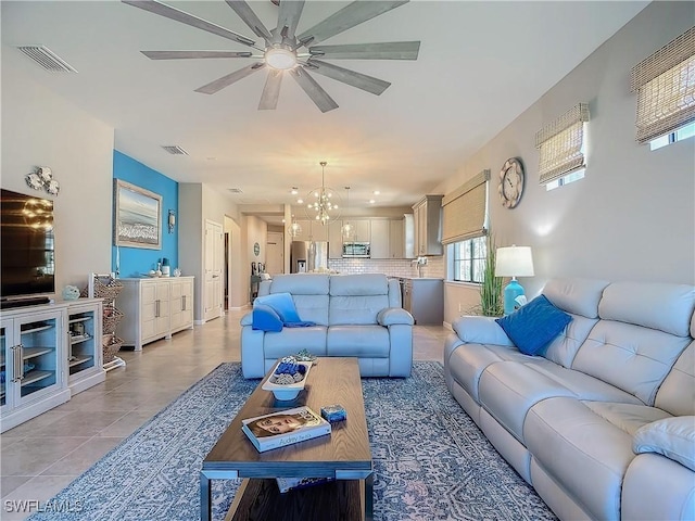 16665 Rolling Rock Blvd, Alva, FL 33920 - living room with a ceiling fan, a chandelier, and light tile patterned floors