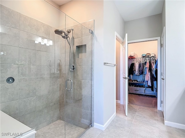 bathroom featuring tile patterned floors and a shower with shower door