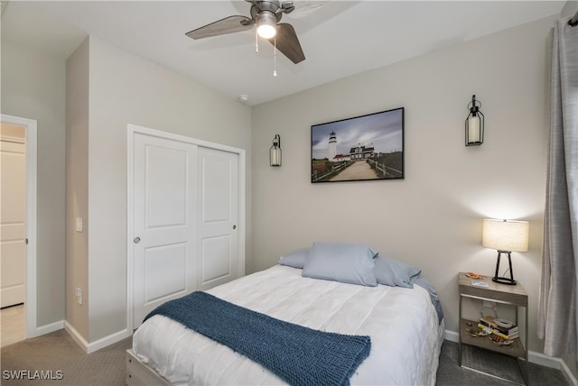 carpeted bedroom with ceiling fan and a closet