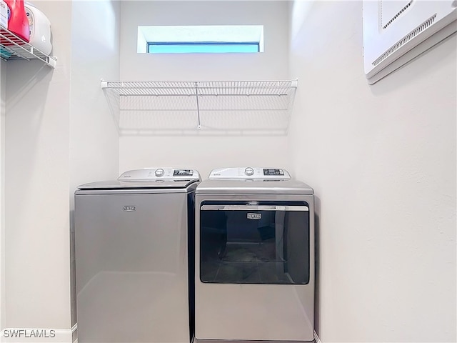 laundry room with separate washer and dryer