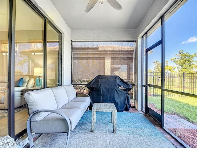 sunroom with plenty of natural light and ceiling fan