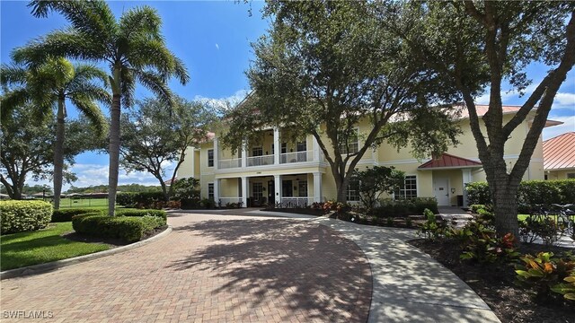 view of front of house featuring covered porch and a balcony