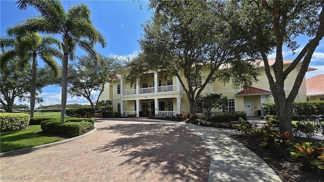 16665 Rolling Rock Blvd, Alva, FL 33920 - obstructed view of property with a balcony, decorative driveway, and a porch
