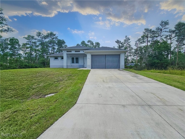 view of front of property featuring a garage and a front lawn