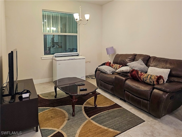 living area with baseboards and a notable chandelier