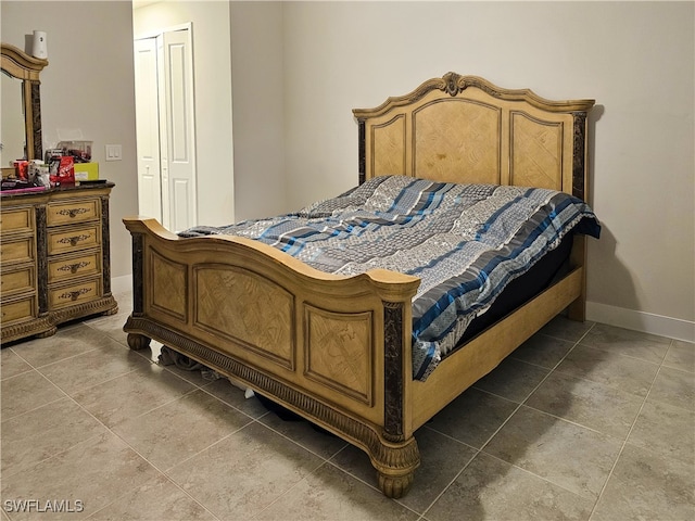 tiled bedroom with a closet