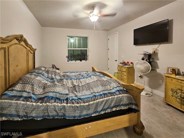 tiled bedroom featuring ceiling fan