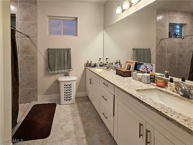 bathroom with vanity and tiled shower