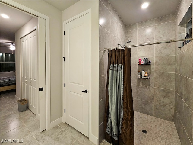 bathroom with curtained shower, tile patterned flooring, and ceiling fan