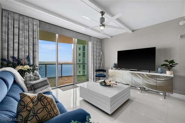 living area with tile patterned flooring, floor to ceiling windows, ceiling fan, and beamed ceiling