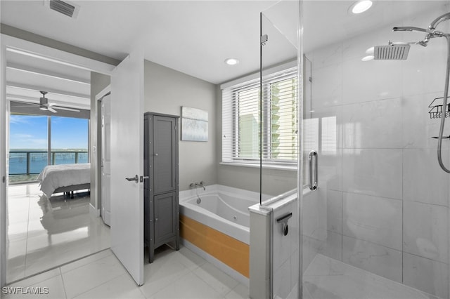 bathroom featuring ceiling fan, separate shower and tub, and a water view