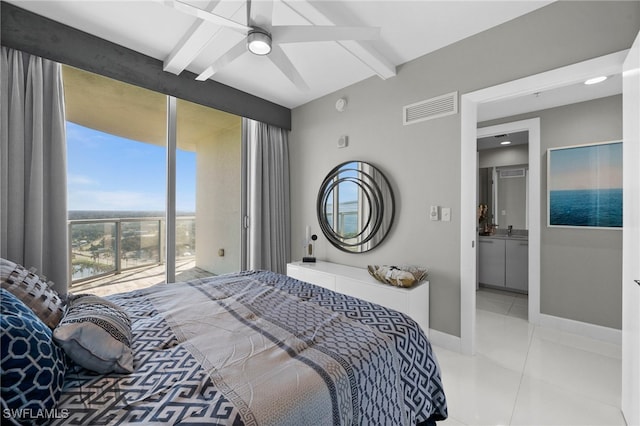 tiled bedroom featuring ceiling fan, ensuite bathroom, and beam ceiling