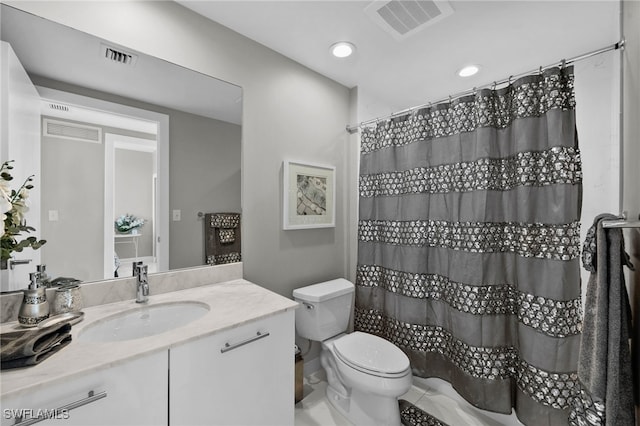 bathroom with walk in shower, vanity, and toilet