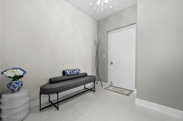 entryway with a chandelier and light tile patterned floors