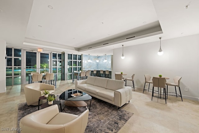 living room featuring a raised ceiling