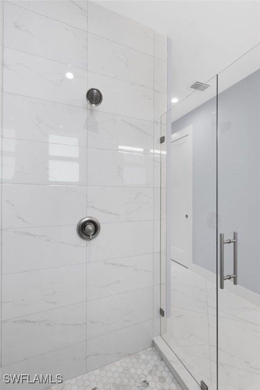 bathroom with a shower with shower door