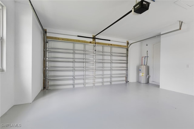 garage with a garage door opener and electric water heater