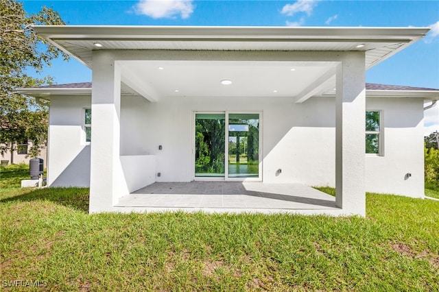 back of house featuring a patio area and a yard