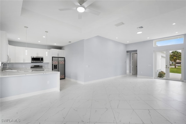 kitchen featuring sink, french doors, decorative light fixtures, white cabinetry, and appliances with stainless steel finishes