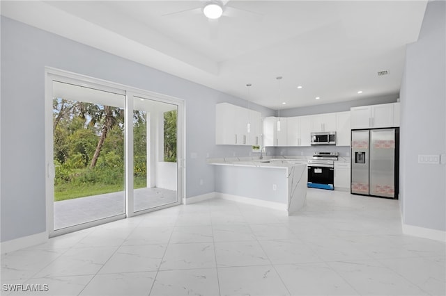 kitchen with sink, white cabinetry, kitchen peninsula, stainless steel appliances, and decorative light fixtures