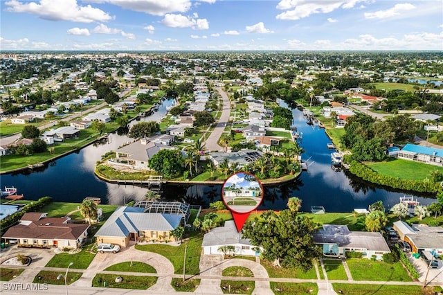 drone / aerial view featuring a water view and a residential view