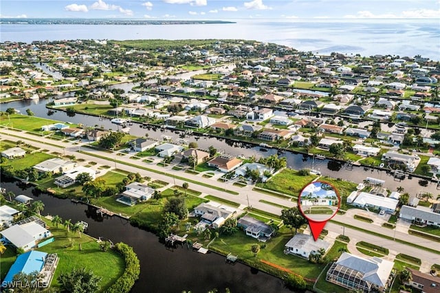 drone / aerial view featuring a water view and a residential view