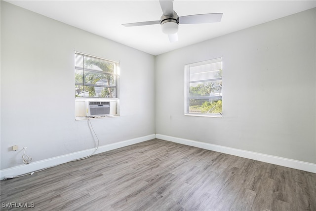 spare room with cooling unit, light hardwood / wood-style flooring, and a wealth of natural light