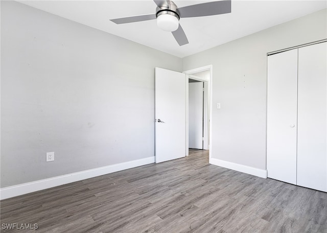 unfurnished bedroom with a closet, light wood-type flooring, and ceiling fan